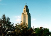 State Capitol tower through fall trees